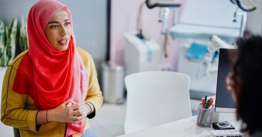a woman speaking with a doctor