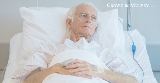 old man looking distraught in hospital bed