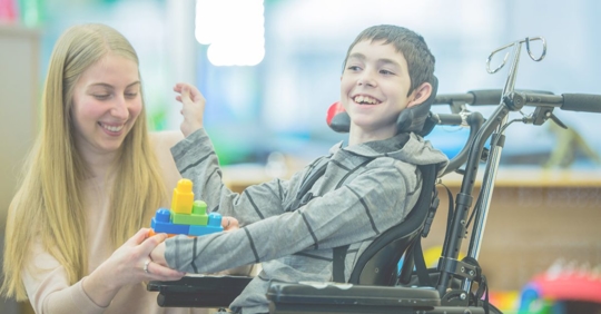 a medical professional and a child with cerebral palsy