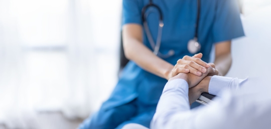 doctor with hands on a patient's hands