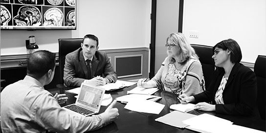 The Crowe and Mulvey team looking over documents and discussing