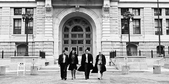 four lawyers walking