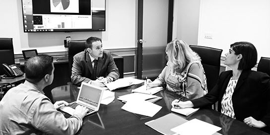 Attorneys Gathered Around a Table Discussing a Case